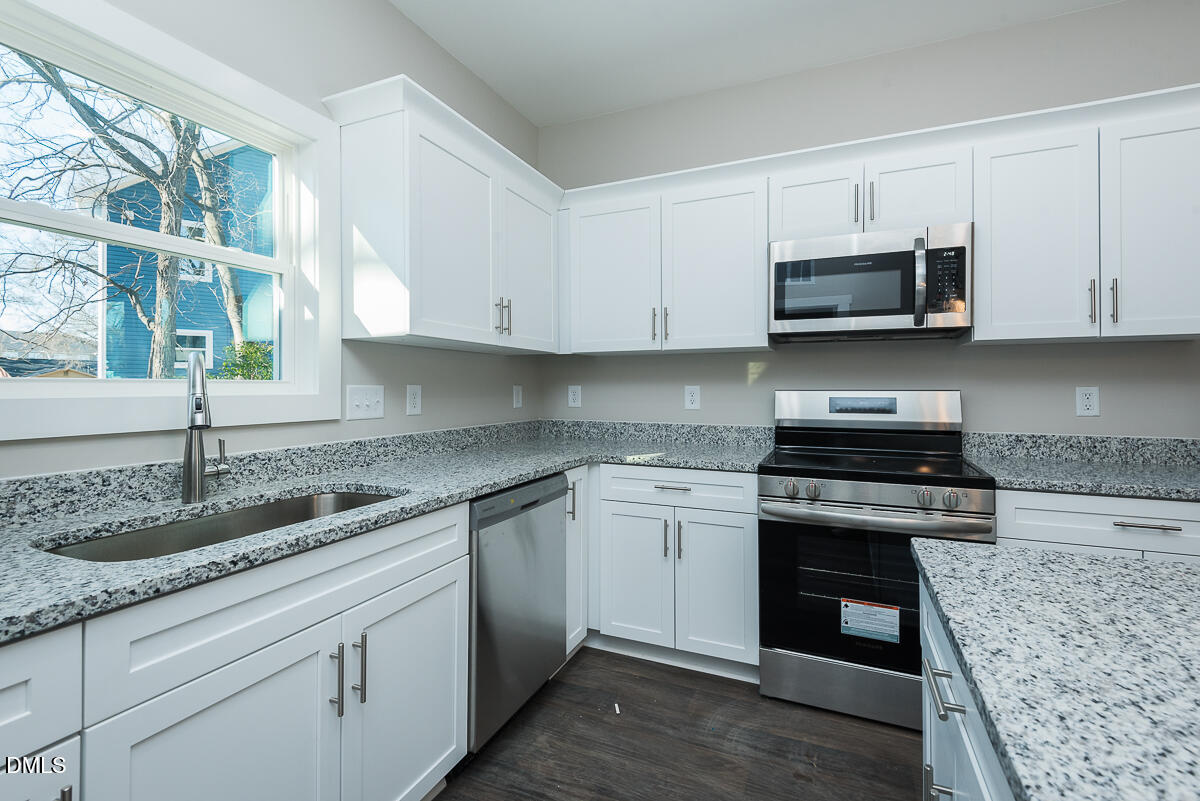 555 Pinnix Road Burlington, NC 27217 - Photo 10 of 21 a kitchen with granite countertop white cabinets and a stove