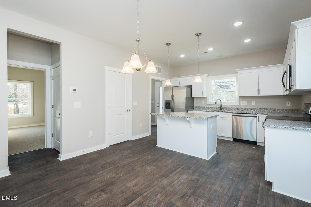 555 Pinnix Road Burlington, NC 27217 - Photo 5 of 21 a kitchen with a refrigerator and a sink