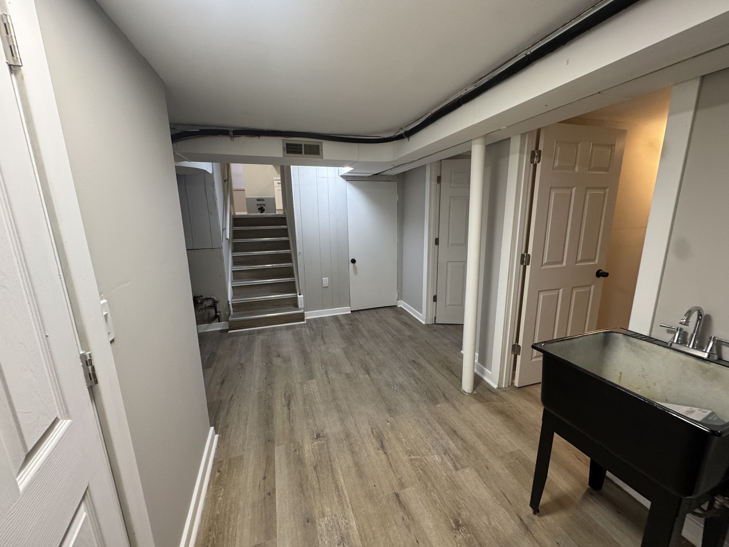 15041 Oak Street Dolton, IL 60419 - Photo 13 of 19 a view of a hallway with wooden floor and stairs