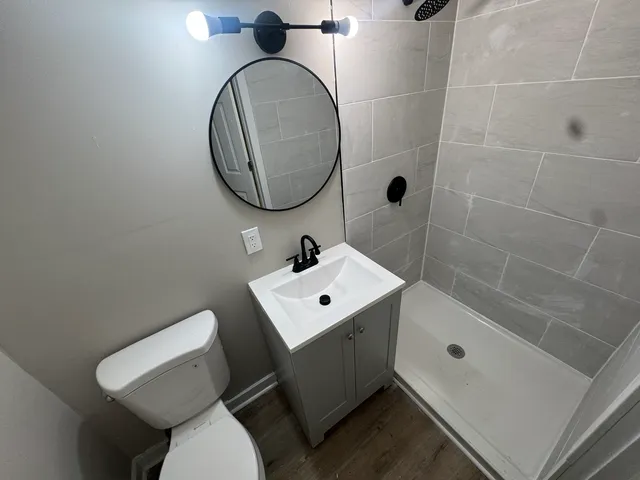 a bathroom with a sink toilet and a mirror