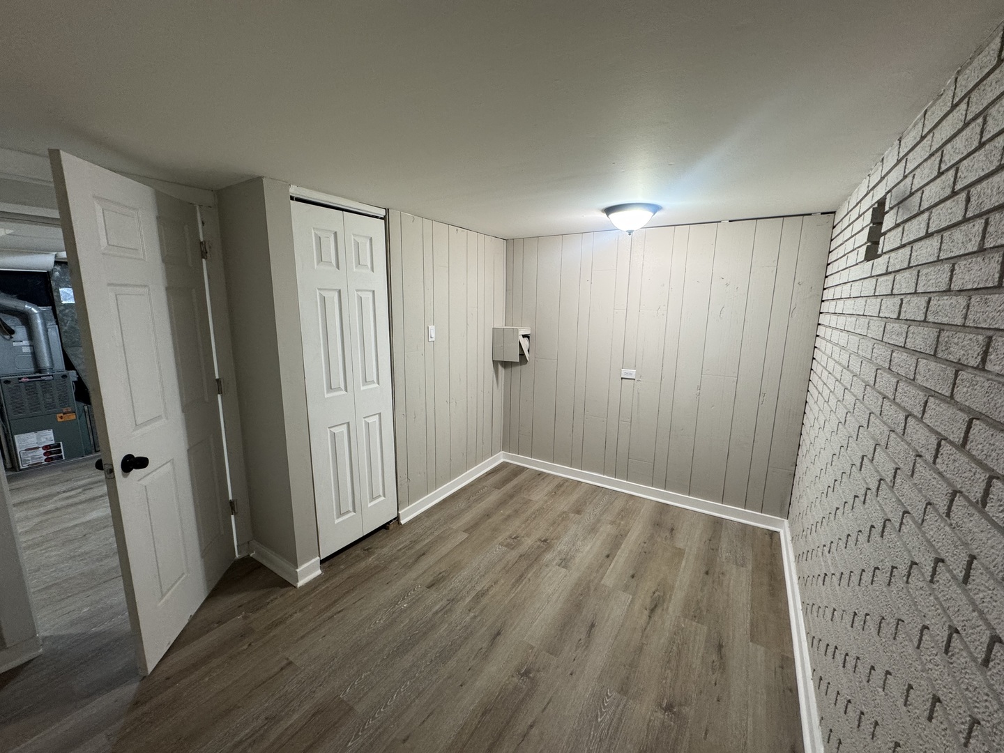 15041 Oak Street Dolton, IL 60419 - Photo 17 of 19 an empty room with wooden floor and a bathroom