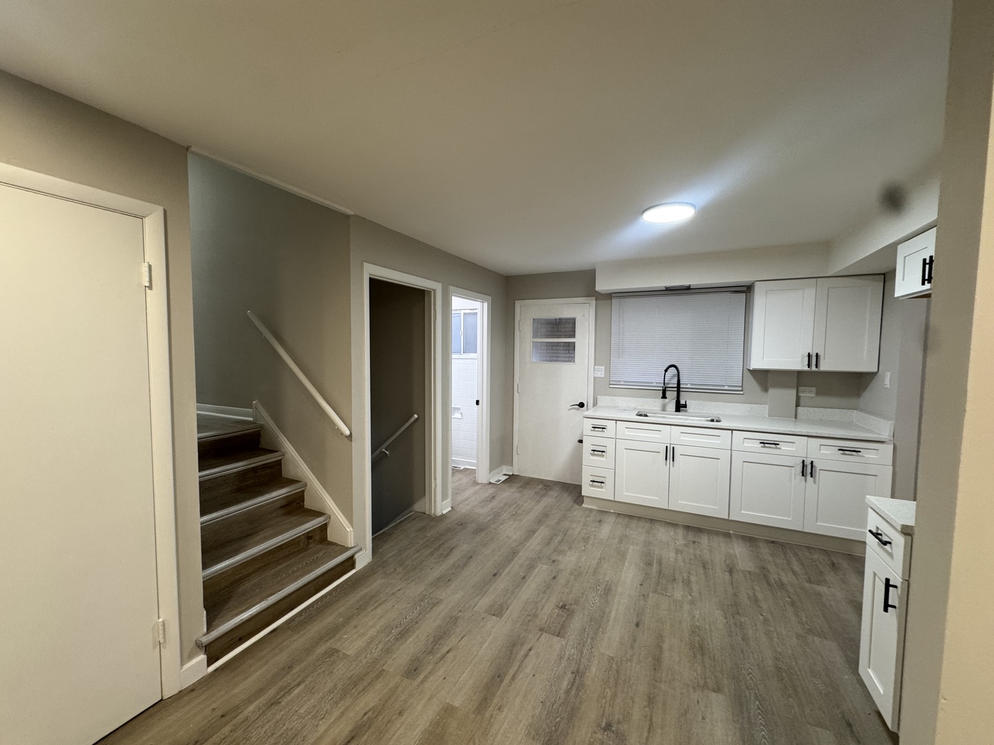 15041 Oak Street Dolton, IL 60419 - Photo 4 of 19 a kitchen with white cabinets and sink