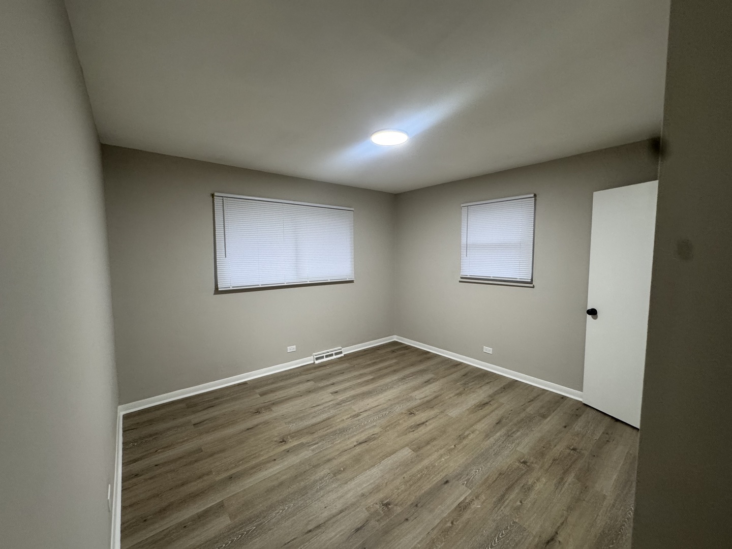 15041 Oak Street Dolton, IL 60419 - Photo 5 of 19 an empty room with wooden floor and windows