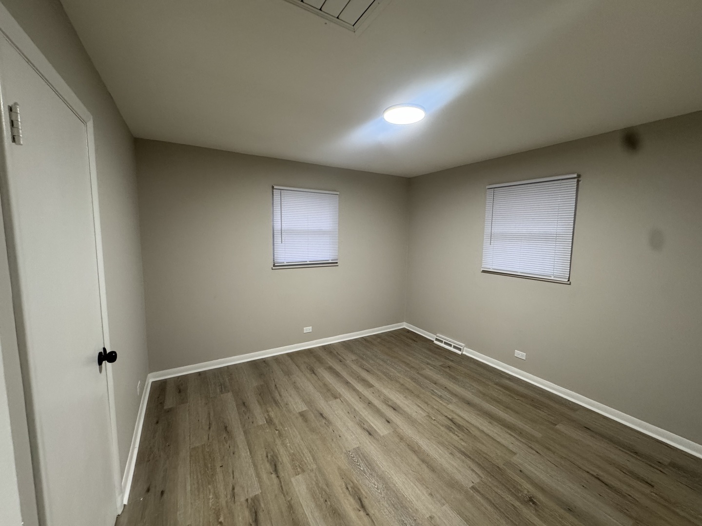 15041 Oak Street Dolton, IL 60419 - Photo 7 of 19 an empty room with wooden floor and windows