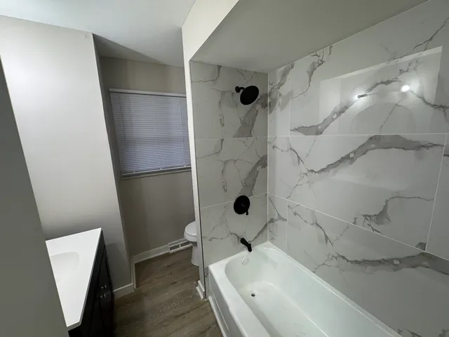 a bathroom with a tub and a sink
