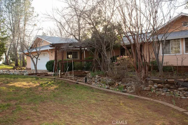 a view of a house with a yard and tree s
