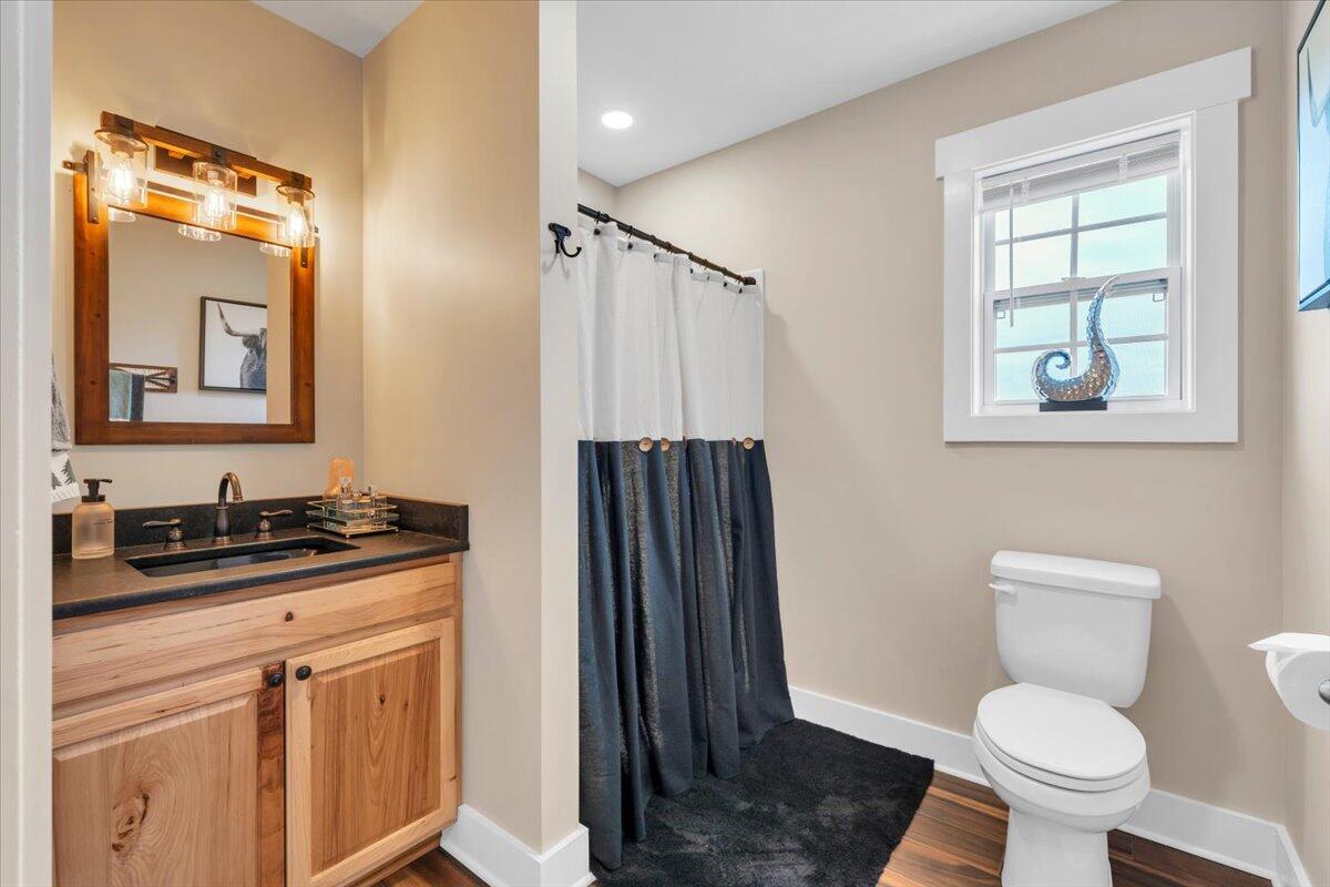 9651 Bent Mountain Road Bent Mountain, VA 24059 - Photo 12 of 71 a bathroom with a granite countertop toilet sink and mirror