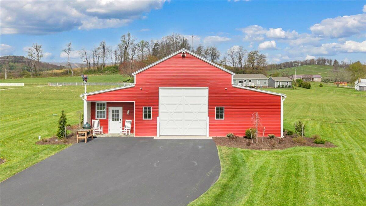 9651 Bent Mountain Road Bent Mountain, VA 24059 - Photo 3 of 71 a front view of a house with a yard and garage