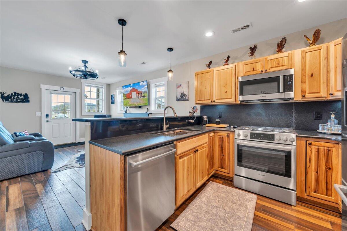 9651 Bent Mountain Road Bent Mountain, VA 24059 - Photo 10 of 71 a kitchen with stainless steel appliances granite countertop a sink and a stove