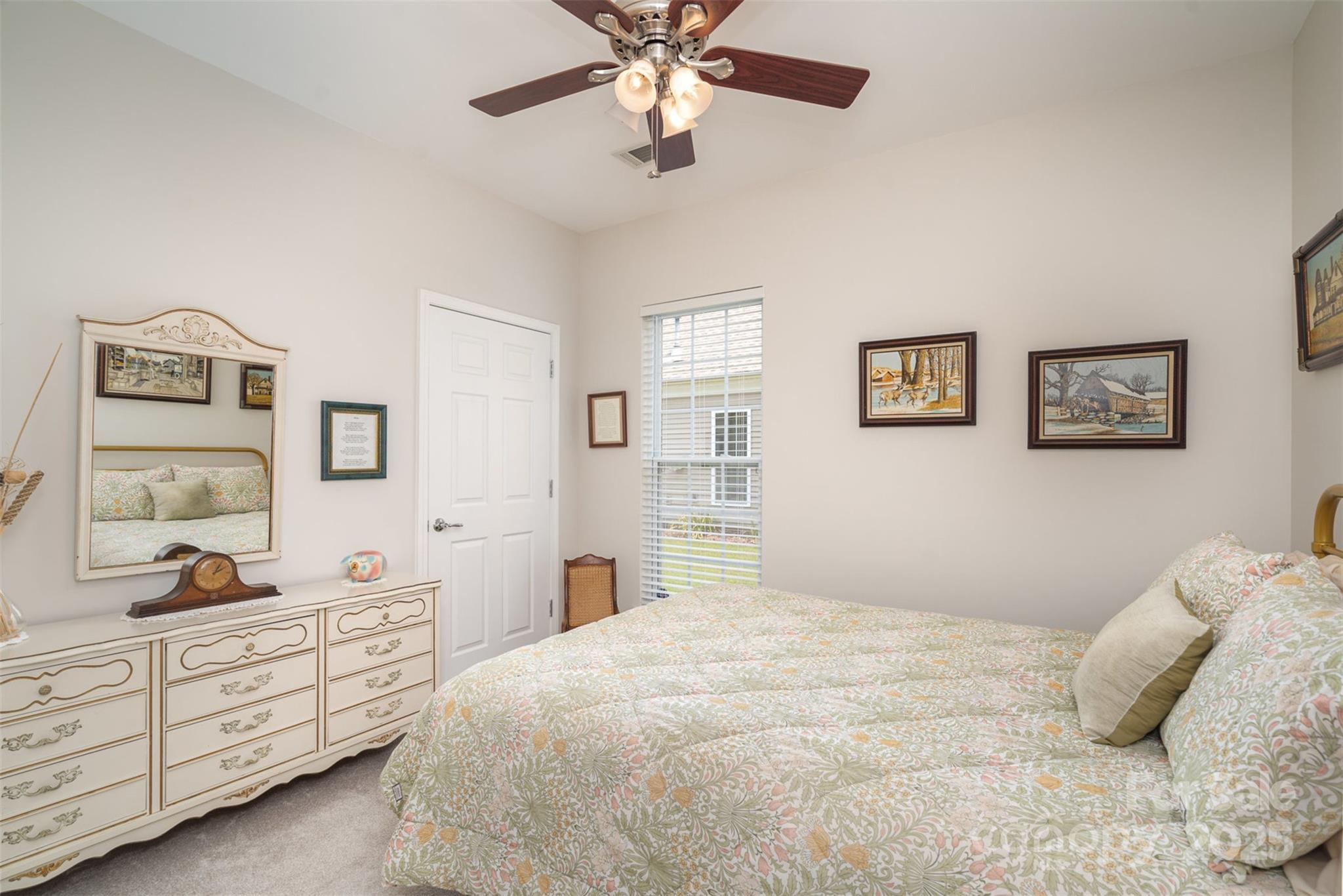 4079 Murray Street Fort Mill, SC 29707 - Photo 15 of 38 a bedroom with a bed and a chandelier
