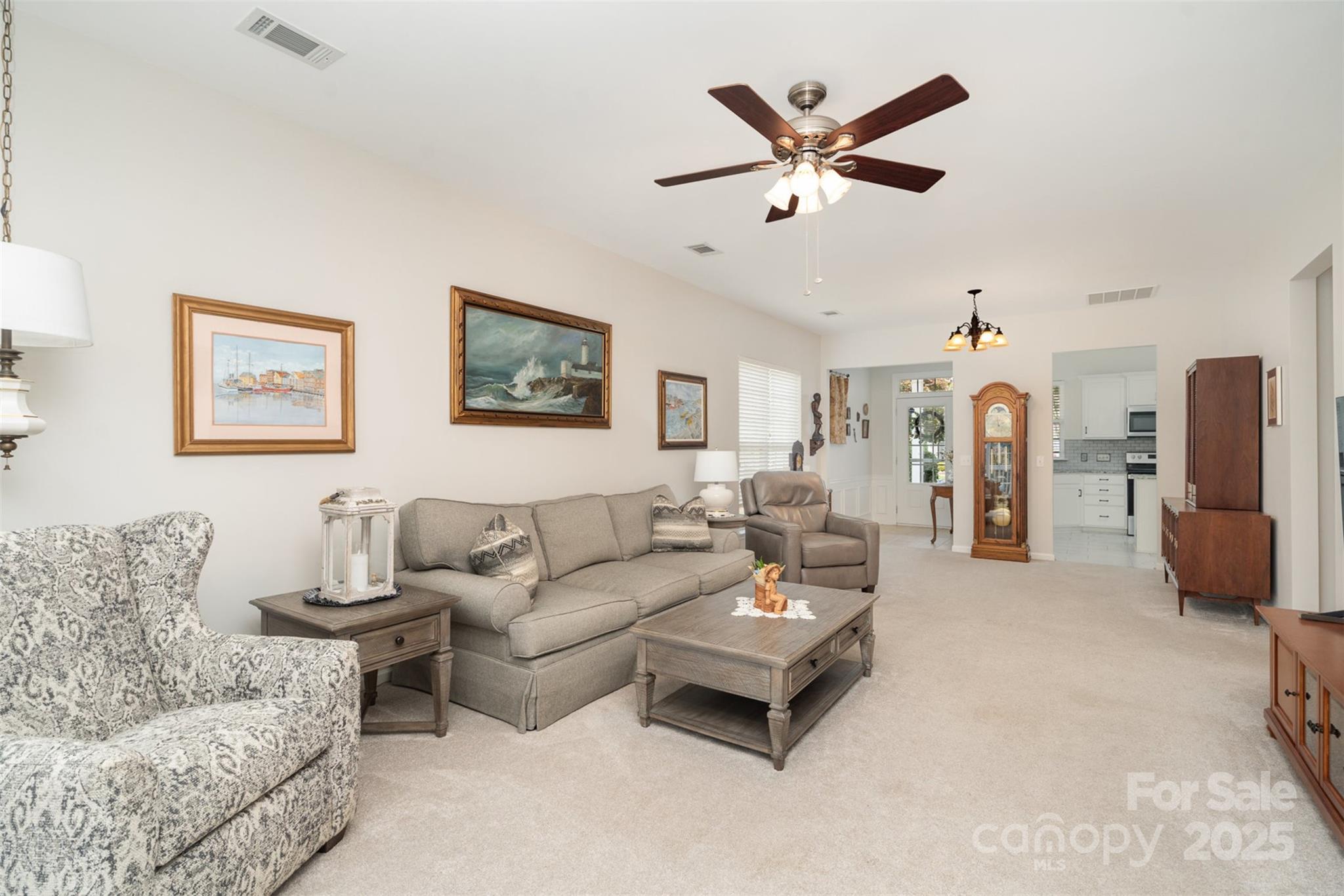 4079 Murray Street Fort Mill, SC 29707 - Photo 7 of 38 a living room with furniture a ceiling fan and a rug