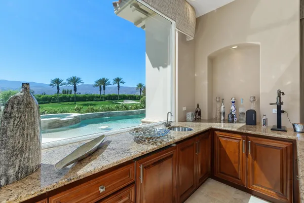 a bathroom with a granite countertop double vanity sink and a mirror
