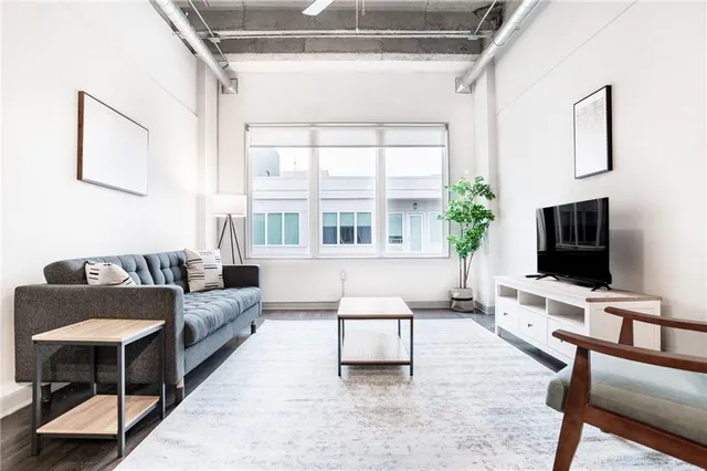a living room with furniture and a flat screen tv