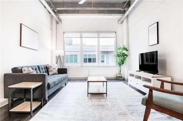 a living room with furniture and a flat screen tv