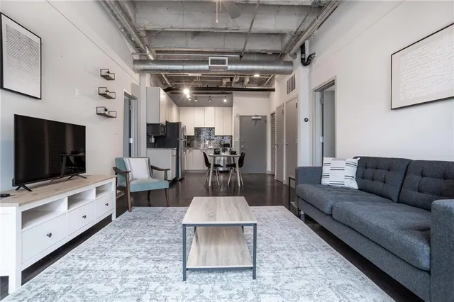 a living room with furniture and a flat screen tv