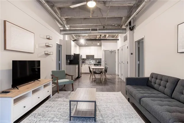 a living room with furniture and a flat screen tv
