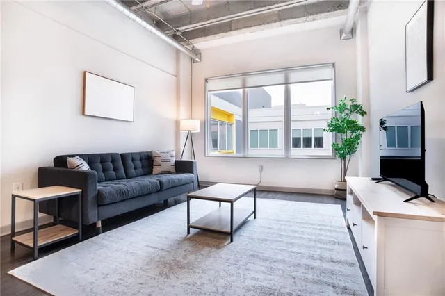 a living room with furniture and a flat screen tv