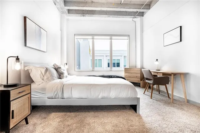 a bedroom with bed and a window