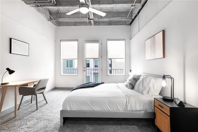 a bedroom with a bed and a desk