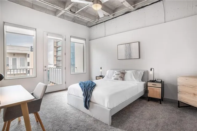 a bedroom with a bed a table and chair