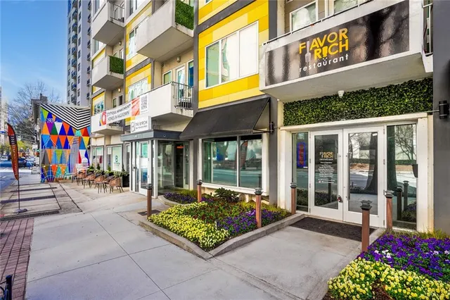 a front view of a multi story building with yard