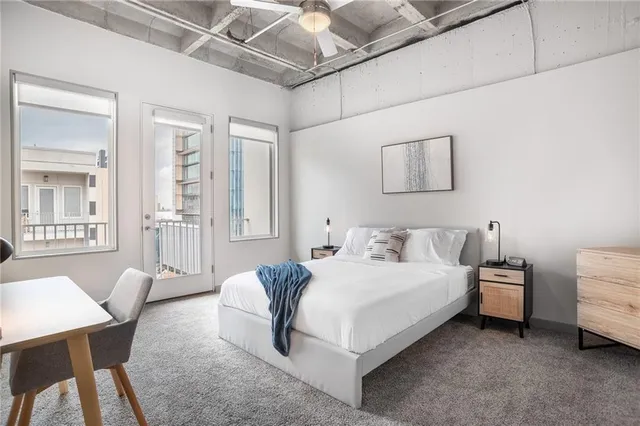 a bedroom with a bed a table and chair