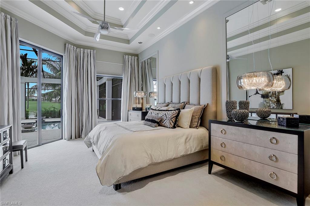 16434 Seneca Way Naples, FL 34110 - Photo 15 of 35 a bedroom with a large bed and a window