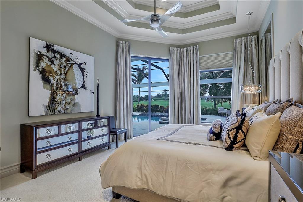 16434 Seneca Way Naples, FL 34110 - Photo 16 of 35 a bed sitting in a spacious bedroom next to a window