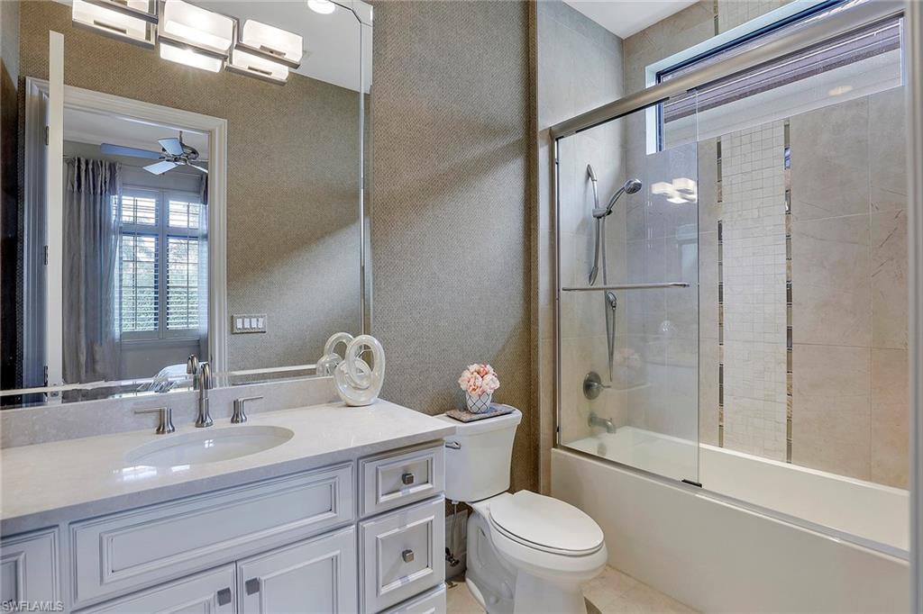 16434 Seneca Way Naples, FL 34110 - Photo 20 of 35 a bathroom with a sink toilet and shower