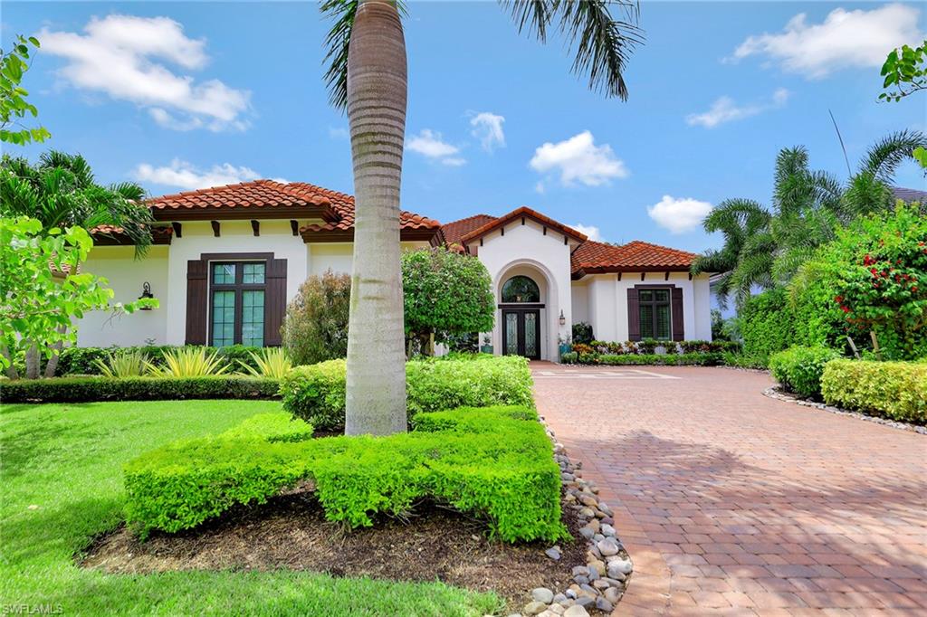 16434 Seneca Way Naples, FL 34110 - Photo 2 of 35 a front view of a house with a yard and garage