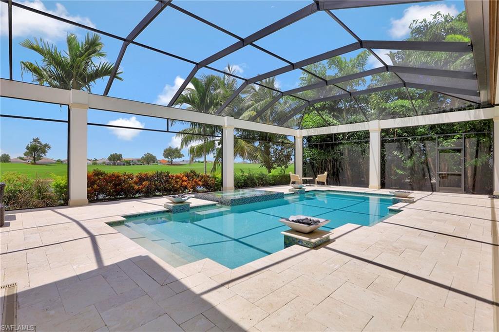 16434 Seneca Way Naples, FL 34110 - Photo 26 of 35 a view of a patio with a table and chairs