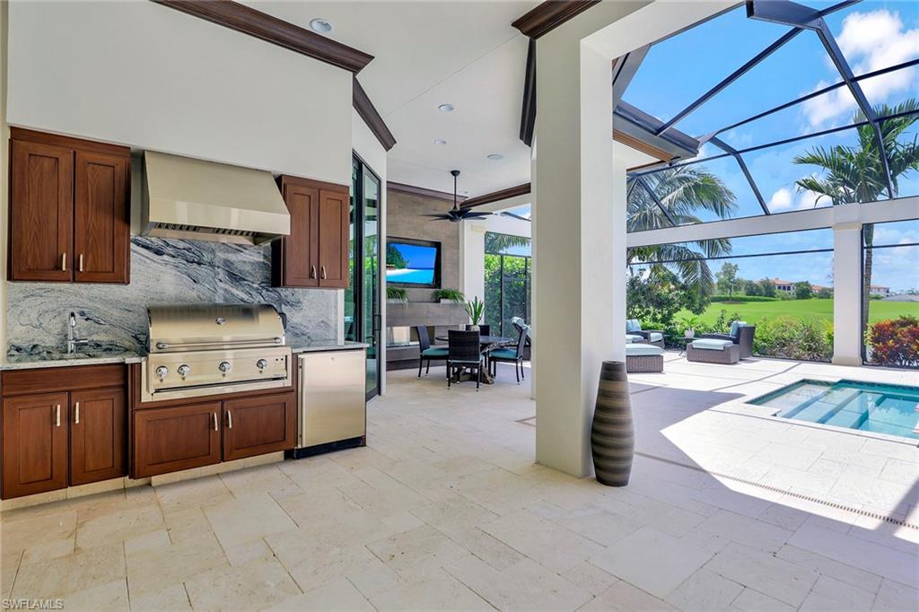16434 Seneca Way Naples, FL 34110 - Photo 30 of 35 a kitchen with stainless steel appliances granite countertop a stove and a sink