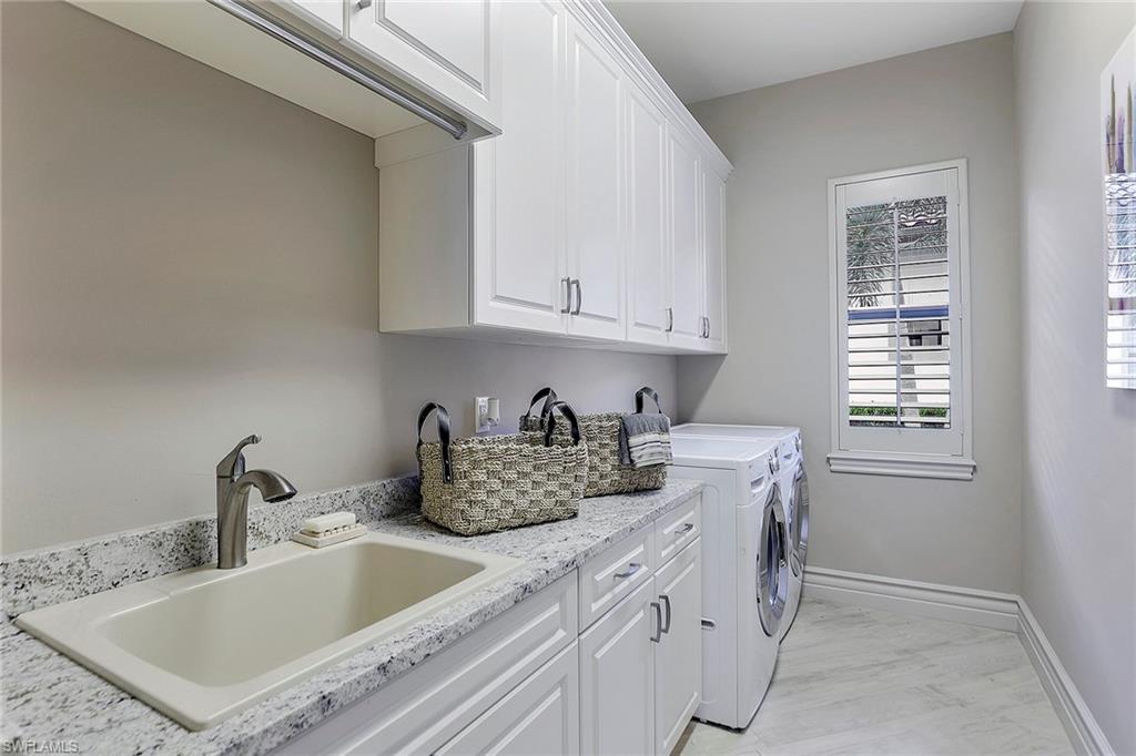 16434 Seneca Way Naples, FL 34110 - Photo 32 of 35 a kitchen with stainless steel appliances granite countertop a sink stove and cabinets