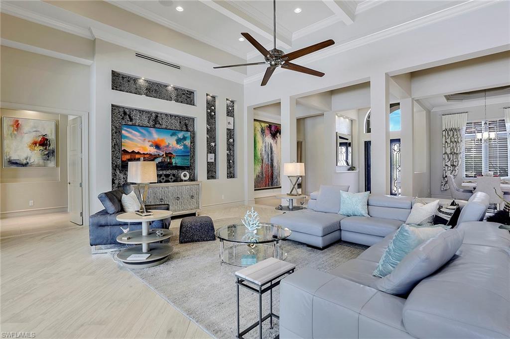 16434 Seneca Way Naples, FL 34110 - Photo 5 of 35 a living room with furniture and a flat screen tv