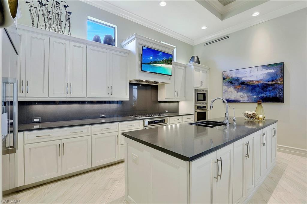 16434 Seneca Way Naples, FL 34110 - Photo 8 of 35 a kitchen with stainless steel appliances granite countertop a sink and a microwave
