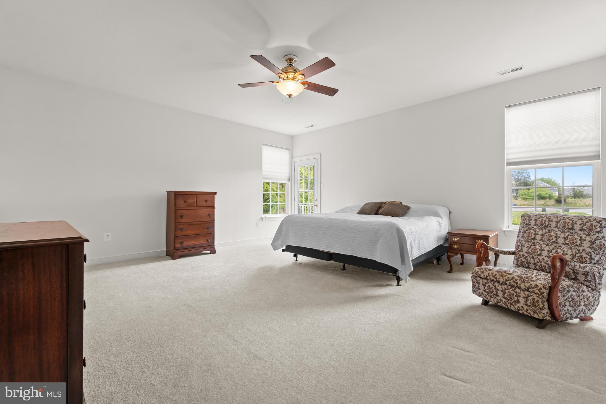 5 St George Ocean View, DE 19970 - Photo 16 of 29 a spacious bedroom with a bed and ceiling fan