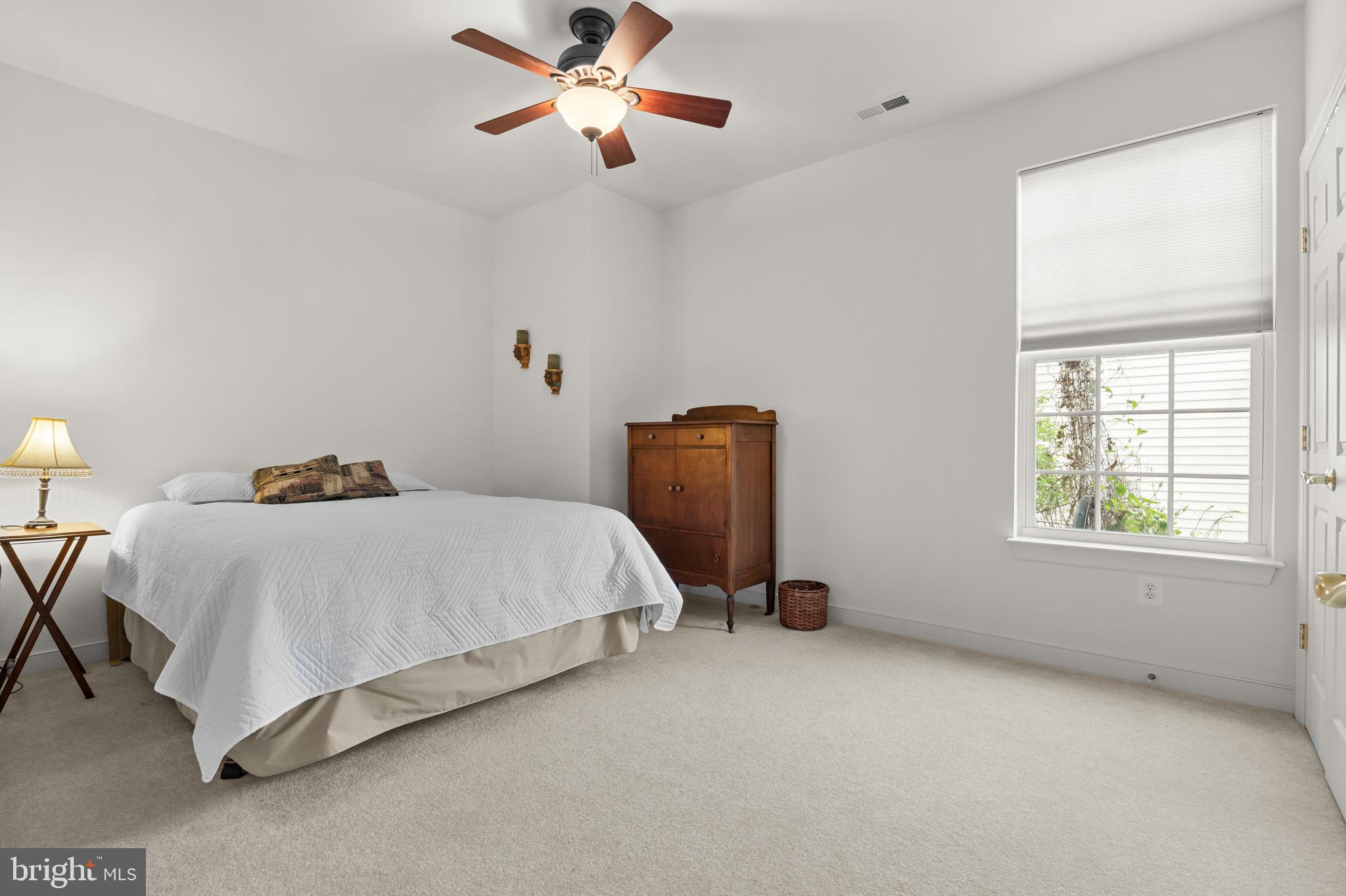 5 St George Ocean View, DE 19970 - Photo 22 of 29 a bedroom with a bed and a chandelier