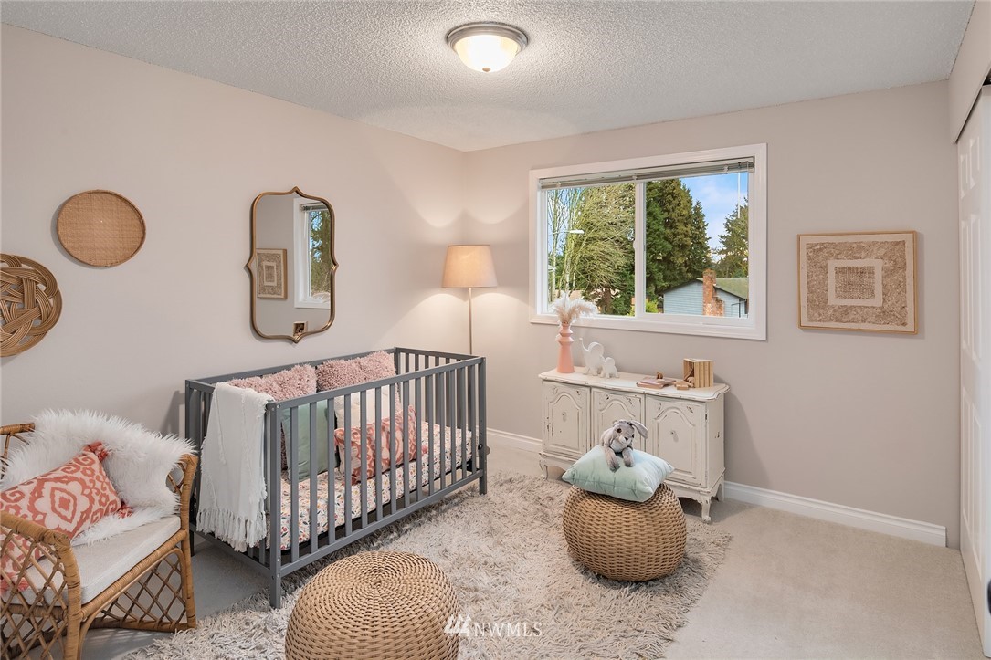 20102 103rd Place Northeast Bothell, WA 98011 - Photo 12 of 22 a bedroom with furniture and windows