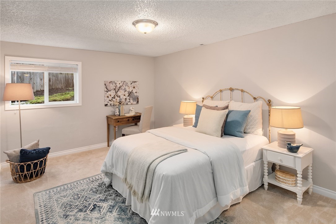 20102 103rd Place Northeast Bothell, WA 98011 - Photo 15 of 22 a bedroom with a bed and wooden floor