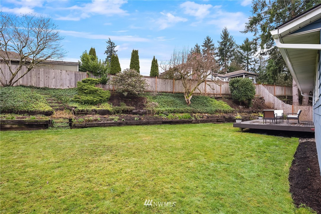 20102 103rd Place Northeast Bothell, WA 98011 - Photo 20 of 22 a view of a garden with a bench in the patio