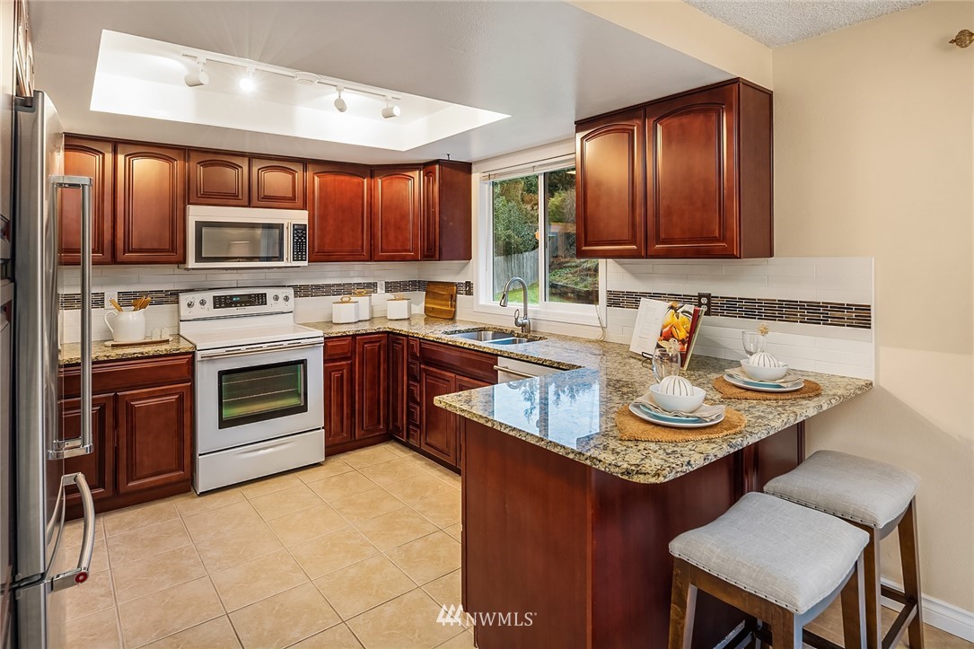 20102 103rd Place Northeast Bothell, WA 98011 - Photo 7 of 22 a kitchen with a sink stove top oven and microwave