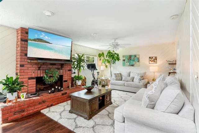 a living room with furniture a flat screen tv and a fireplace