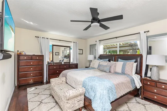 a bedroom with a bed window and a ceiling fan