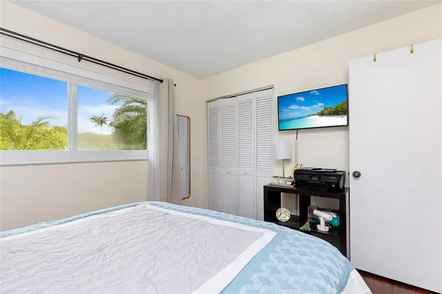 a bedroom with a bed and a desk