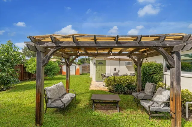 a front view of a house with garden and patio