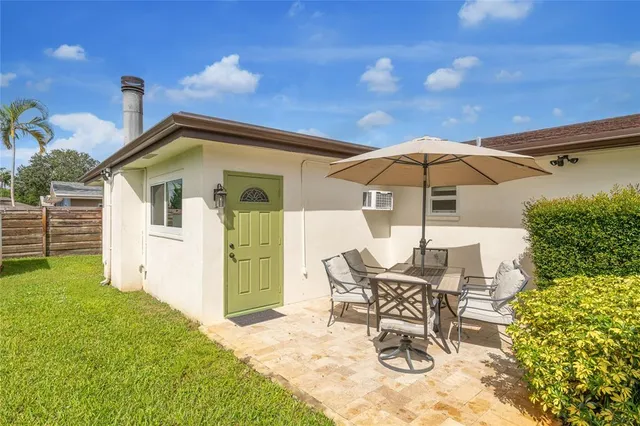 a patio with a yard table and chairs