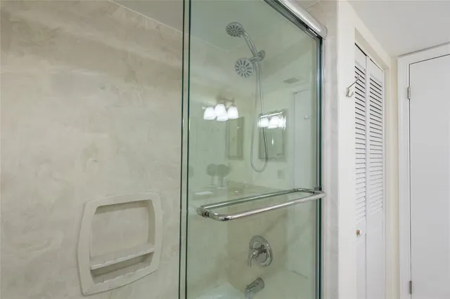 a bathroom with a glass shower door