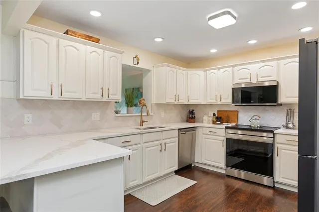 a kitchen with a sink a stove and cabinets