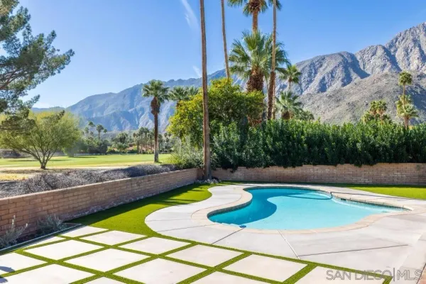 a view of a swimming pool with a yard