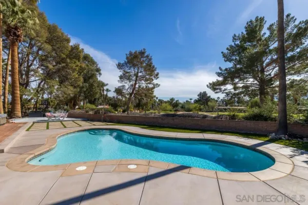 a view of a swimming pool with a patio